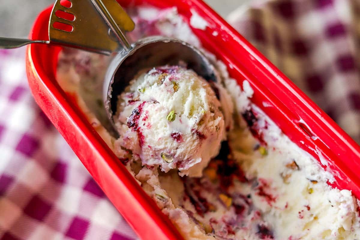 huckleberry ice cream being scooped from a red tub.