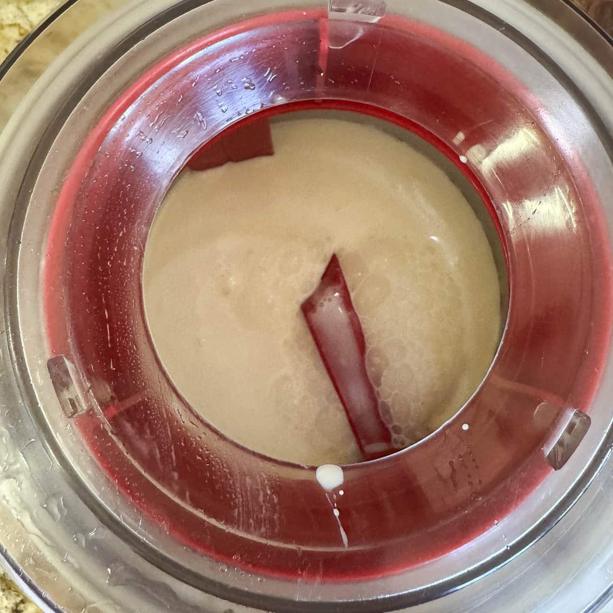 vanilla ice cream being churned in an ice cream maker