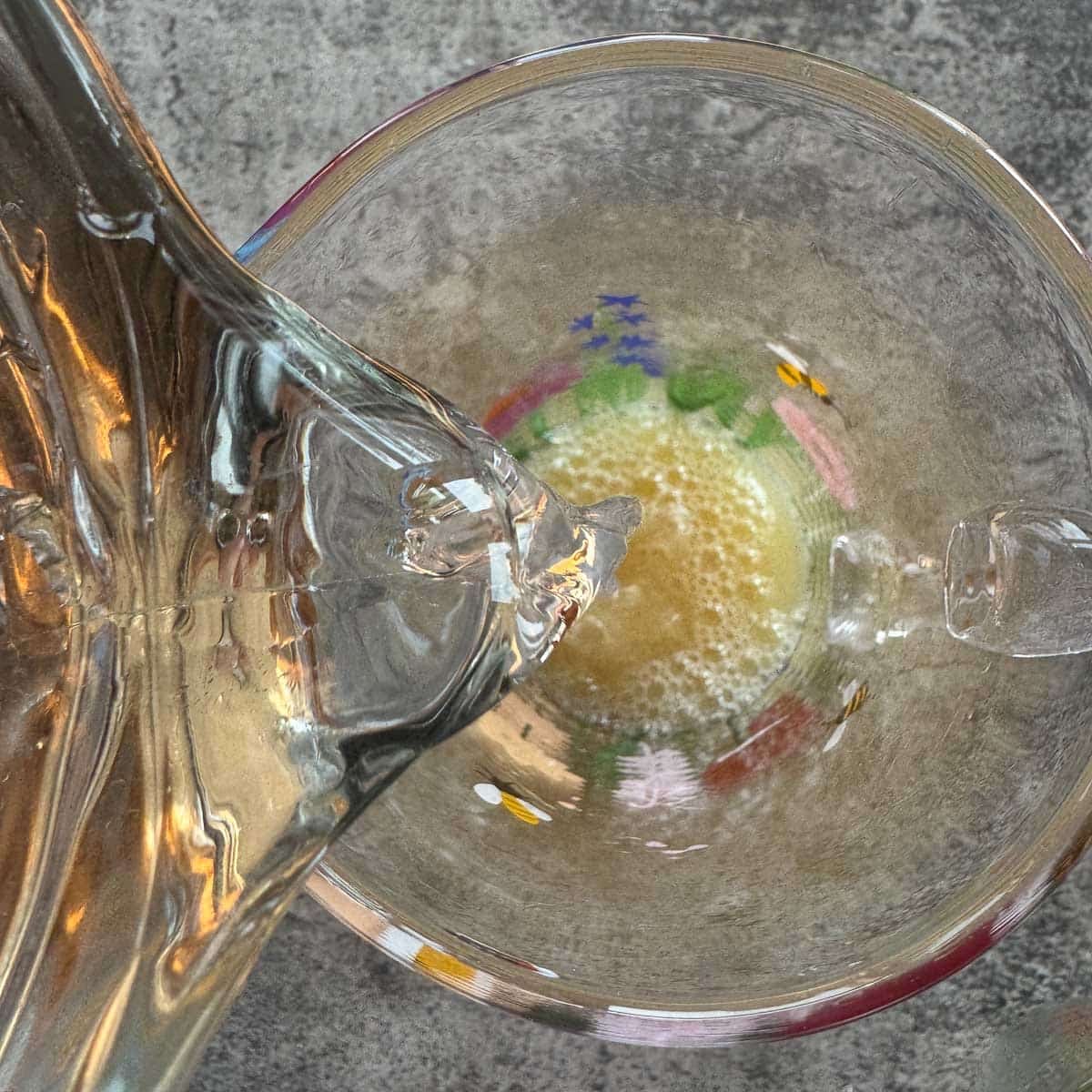 pouring water over freshly squeezed lemon juice in a pitcher