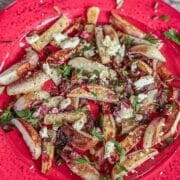 roasted turnips and onions on a red plate
