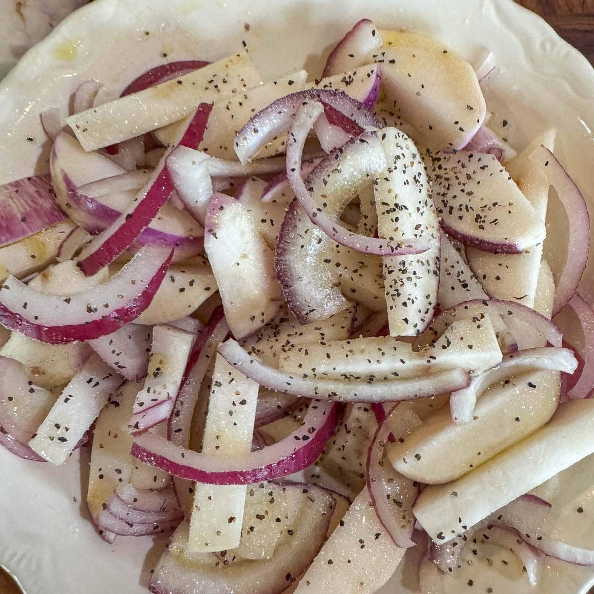 sliced turnips and onions seasoned with salt and black pepper.