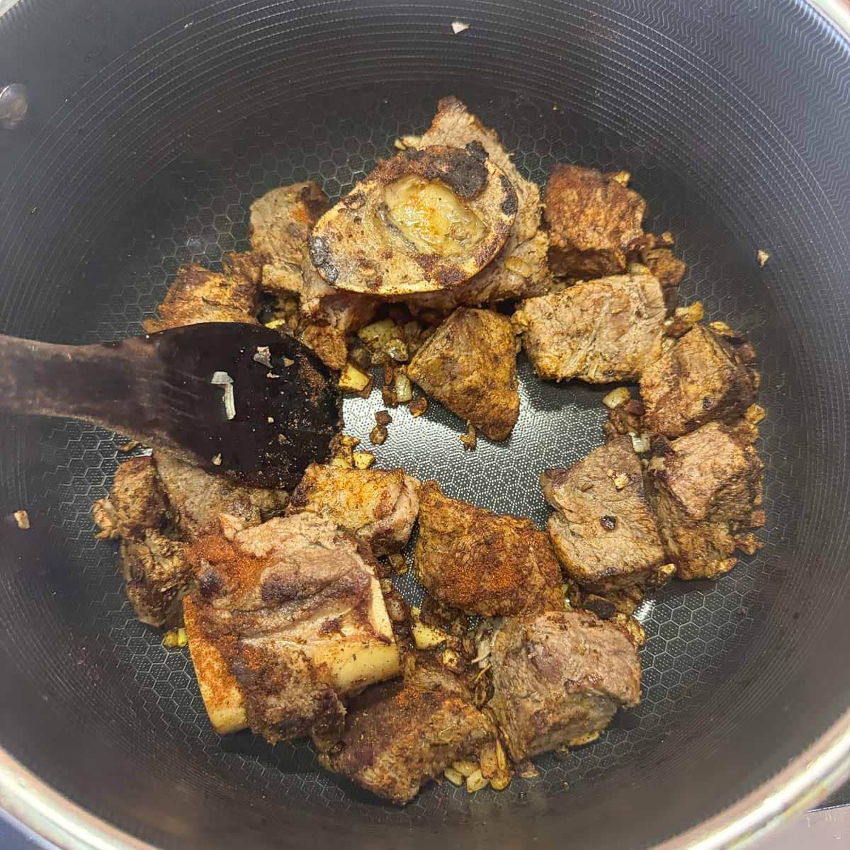 chopped meat and onions in a pot