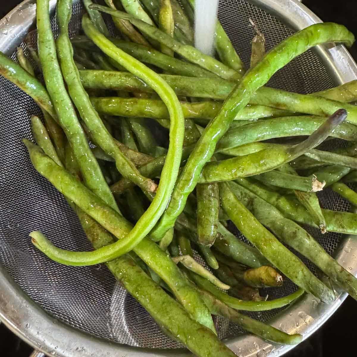 long beans in a strainer
