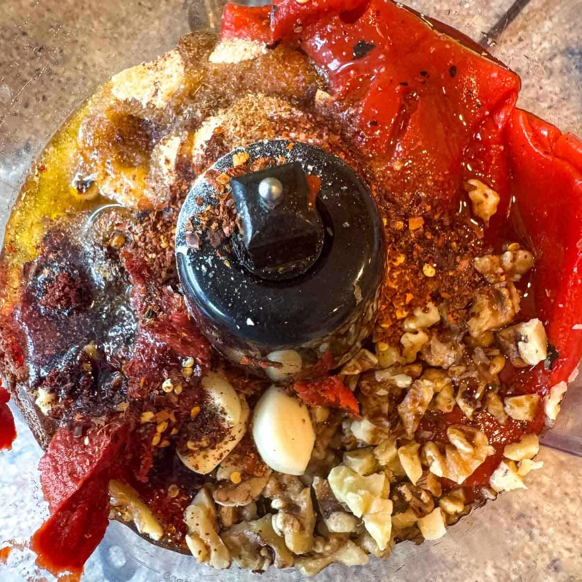 muhammara ingredients in a food processor