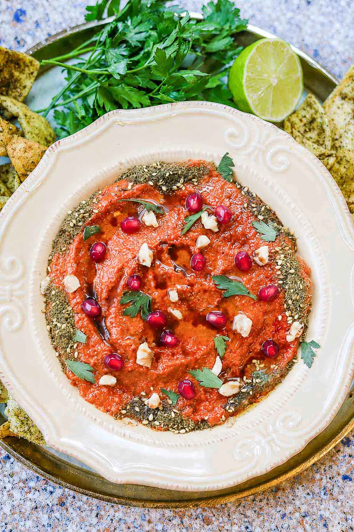 muhammara recipe with chips, parsley, and lime
