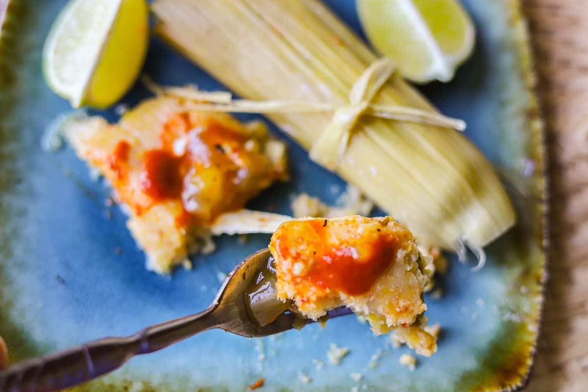 corn tamales with hot sauce on top