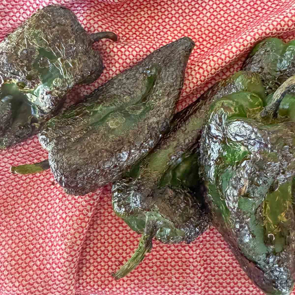 roasted poblanos on a red dishcloth