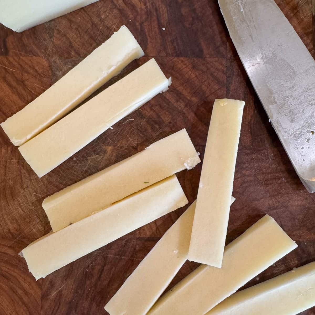 sliced cheese on a cutting board