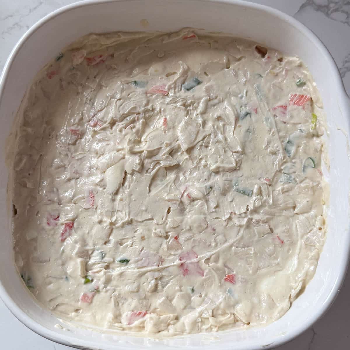 crab rangoon dip mixture in baking pan.