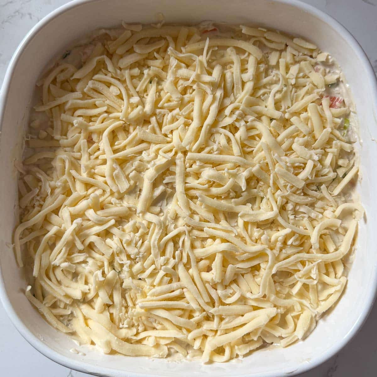 cheese on top of crab rangoon dip before baking.