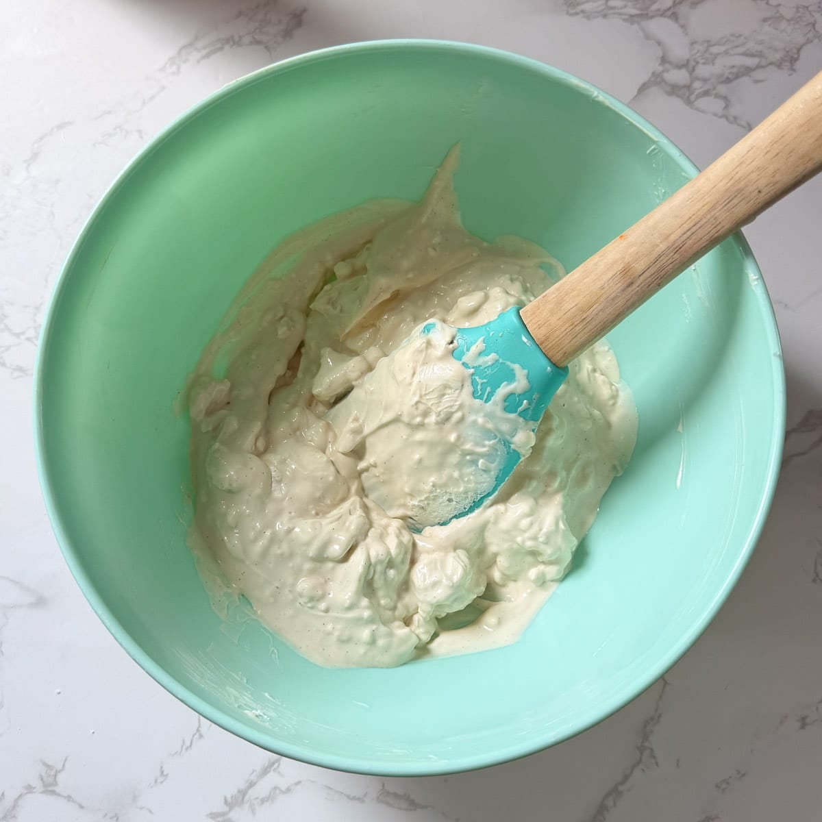 cream cheese mixture being mixed with spatula.