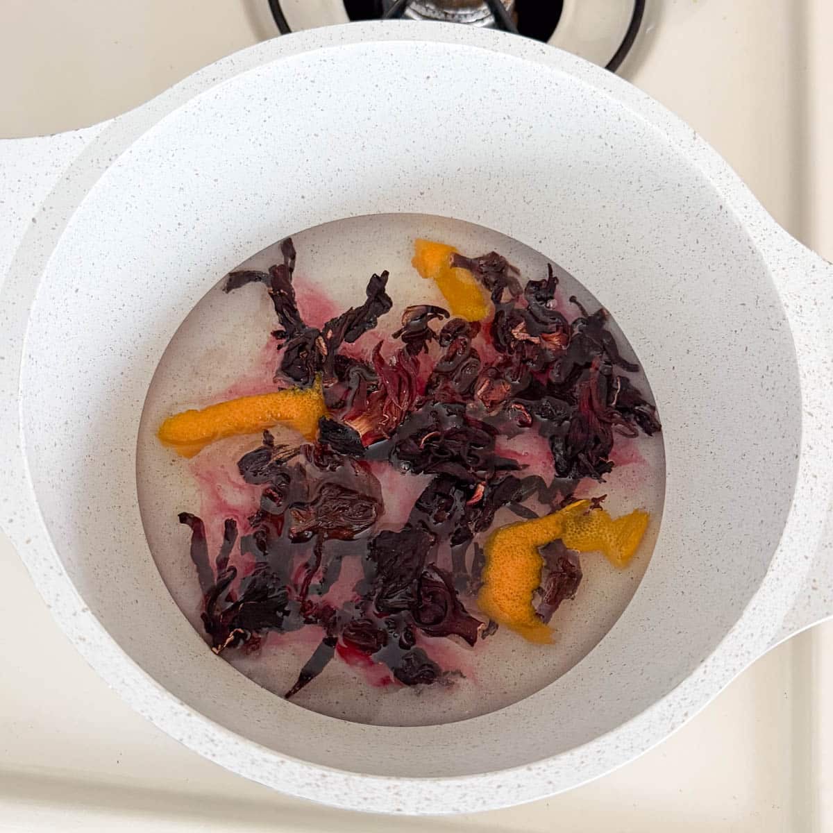 hibiscus and orange peel steeping in pot.