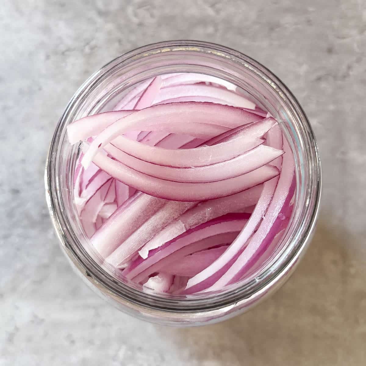 sliced onions in jar.