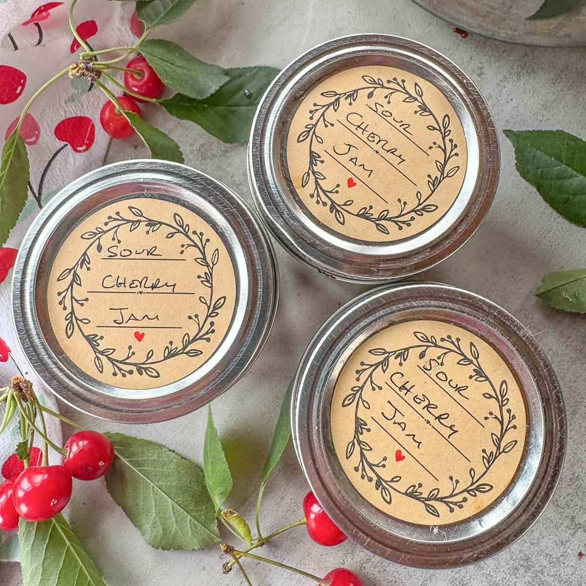 3 jars of chia jam with cherries around it