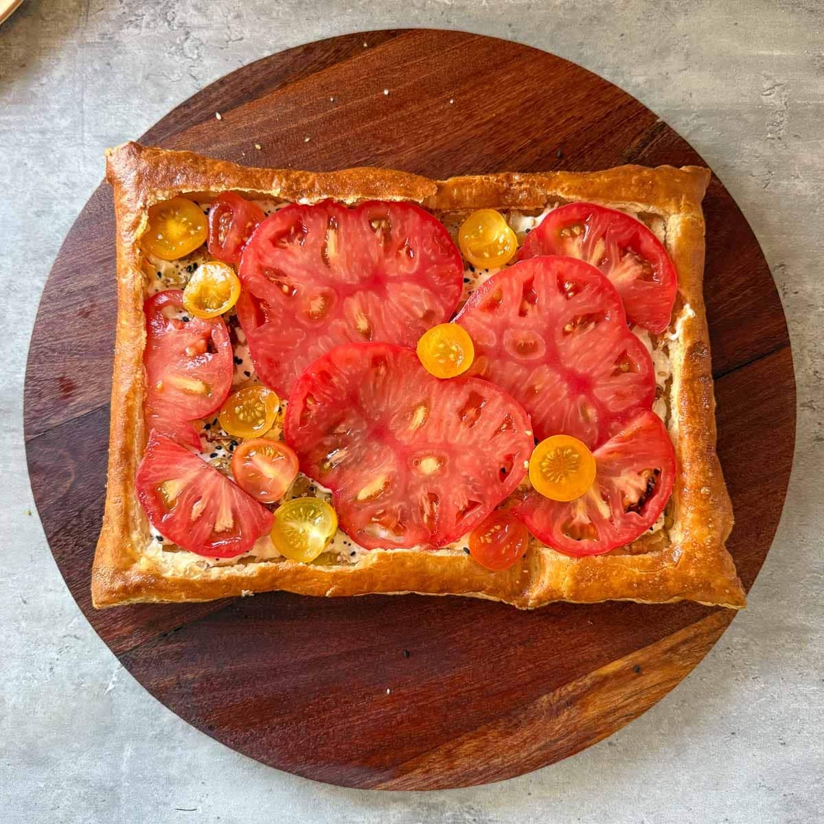 tomatoes added to puff pastry tart.