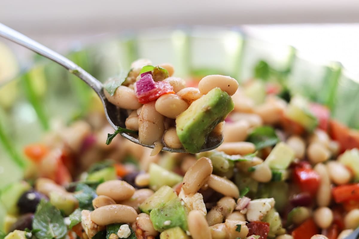 white bean salad in a bowl with a spoonful over it