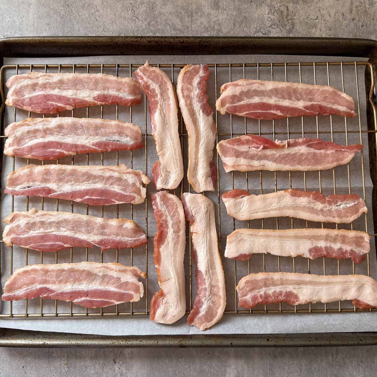 halved bacon strips arranged in a single layer on a wire rack over baking sheet.