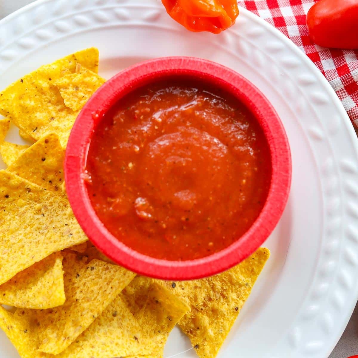 habanero salsa in a red bowl with chips