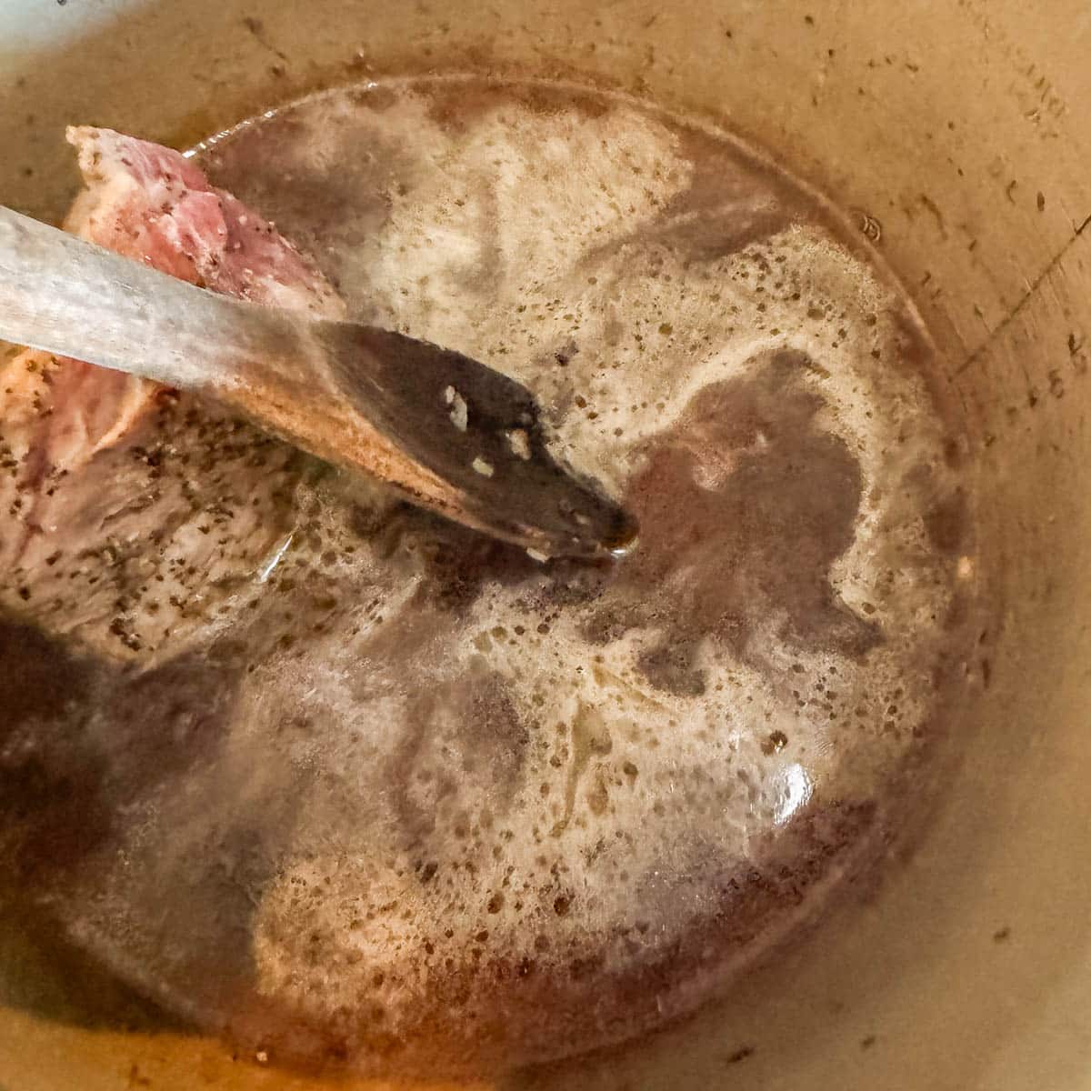 pot being deglazed with water