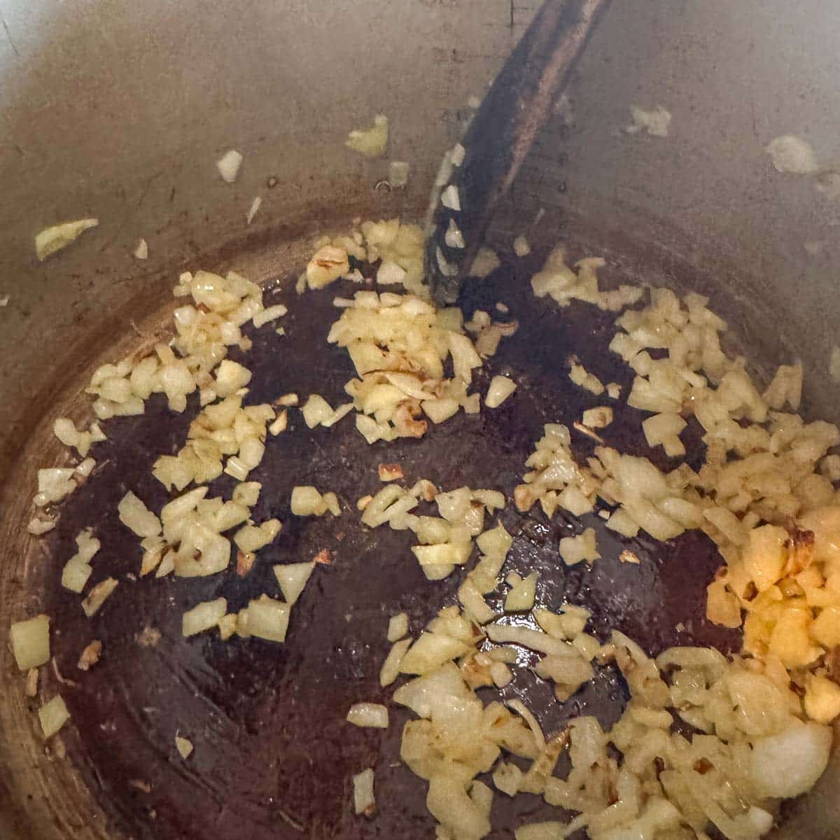 diced onion being sauteed in a pot