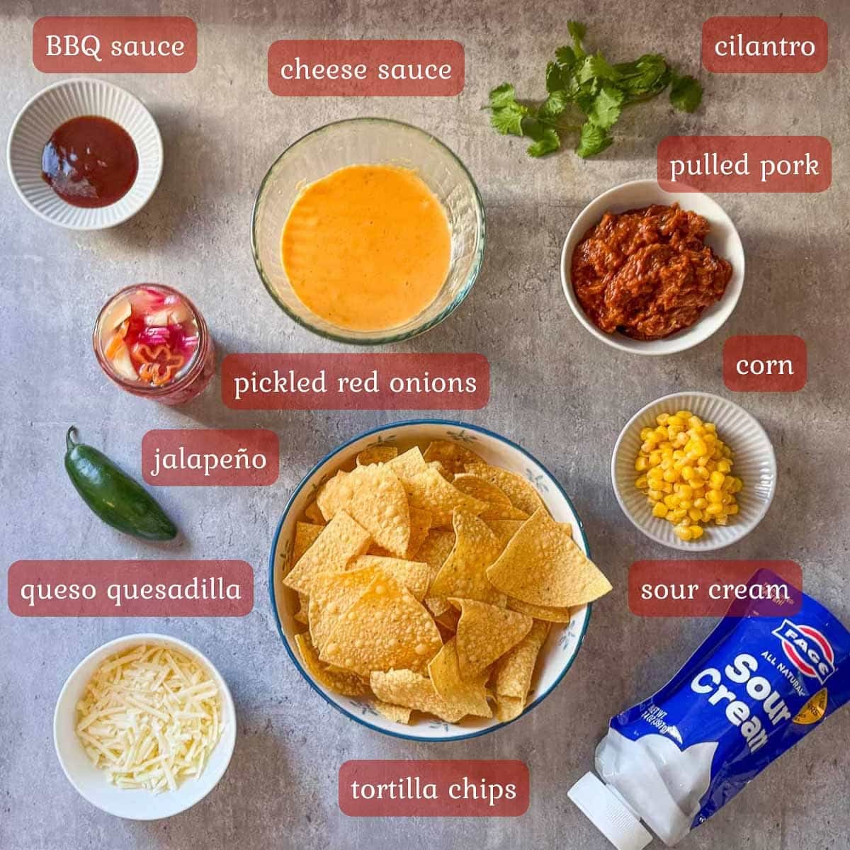 pulled pork nachos recipe ingredients (chips, cheese, pork, toppings).