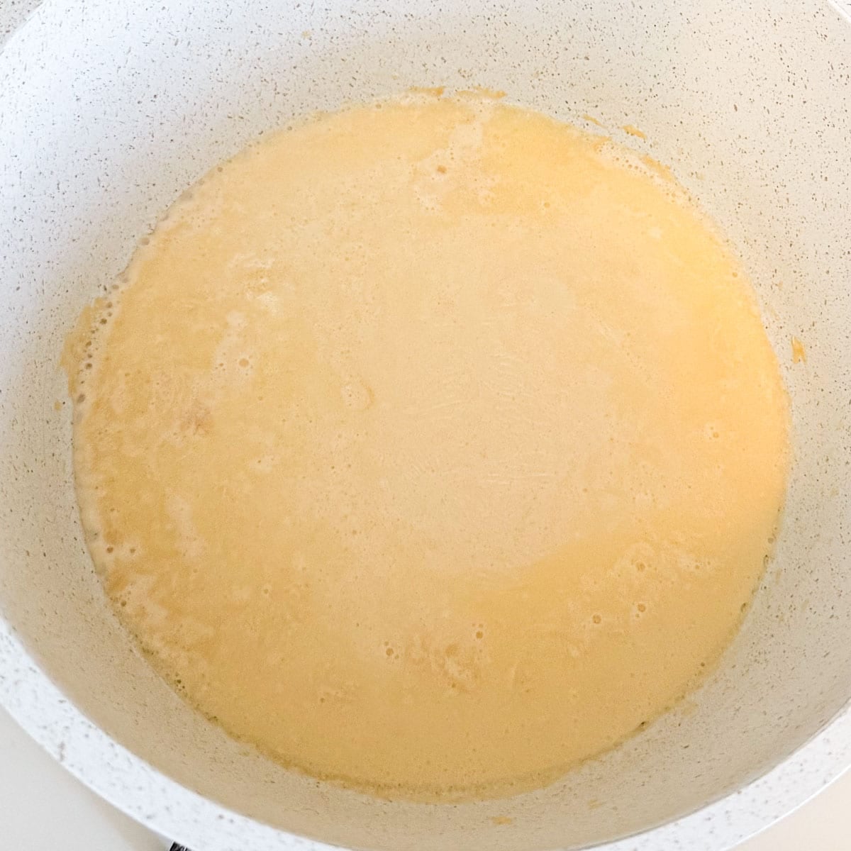 evaporated milk simmering in pot.