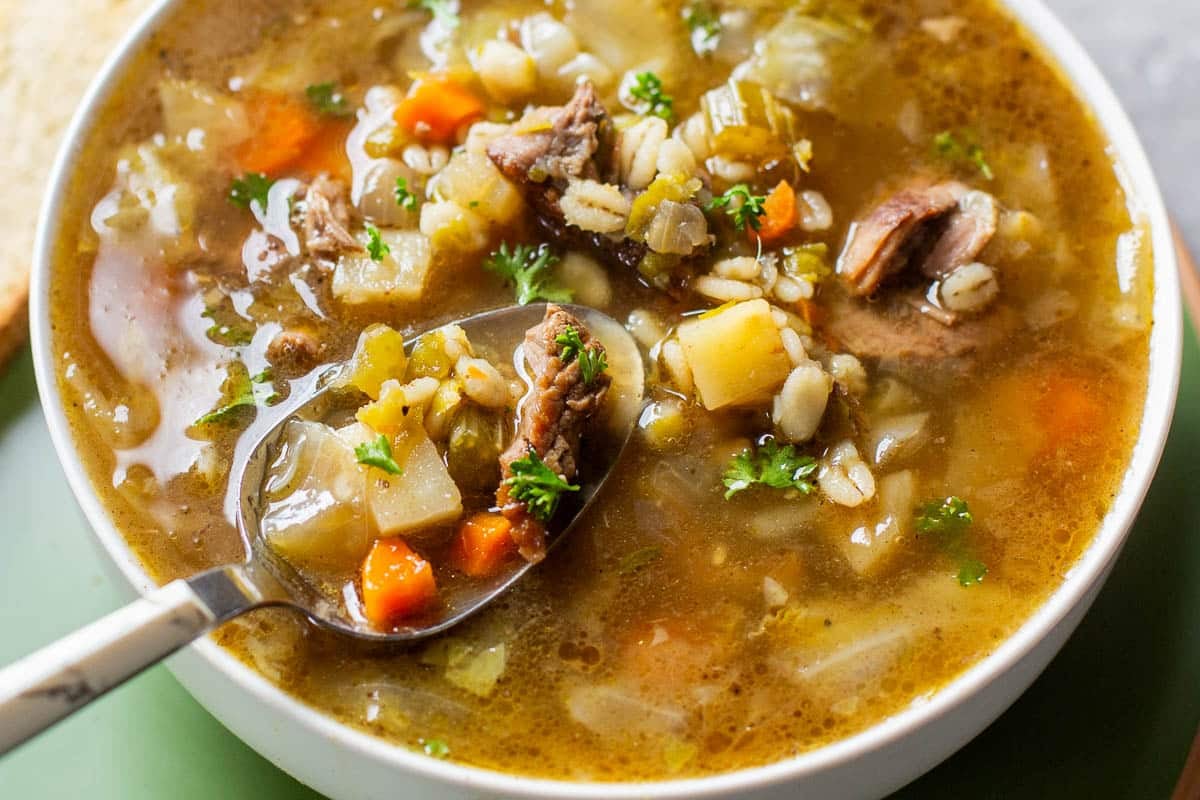 spoon scooping scotch broth out of bowl.