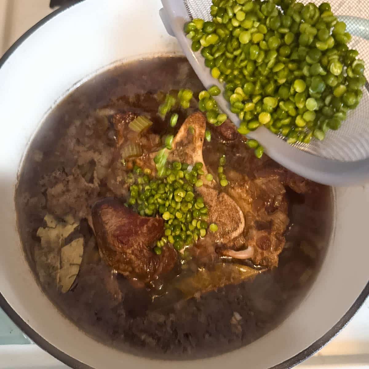 split peas being added to Scotch broth.