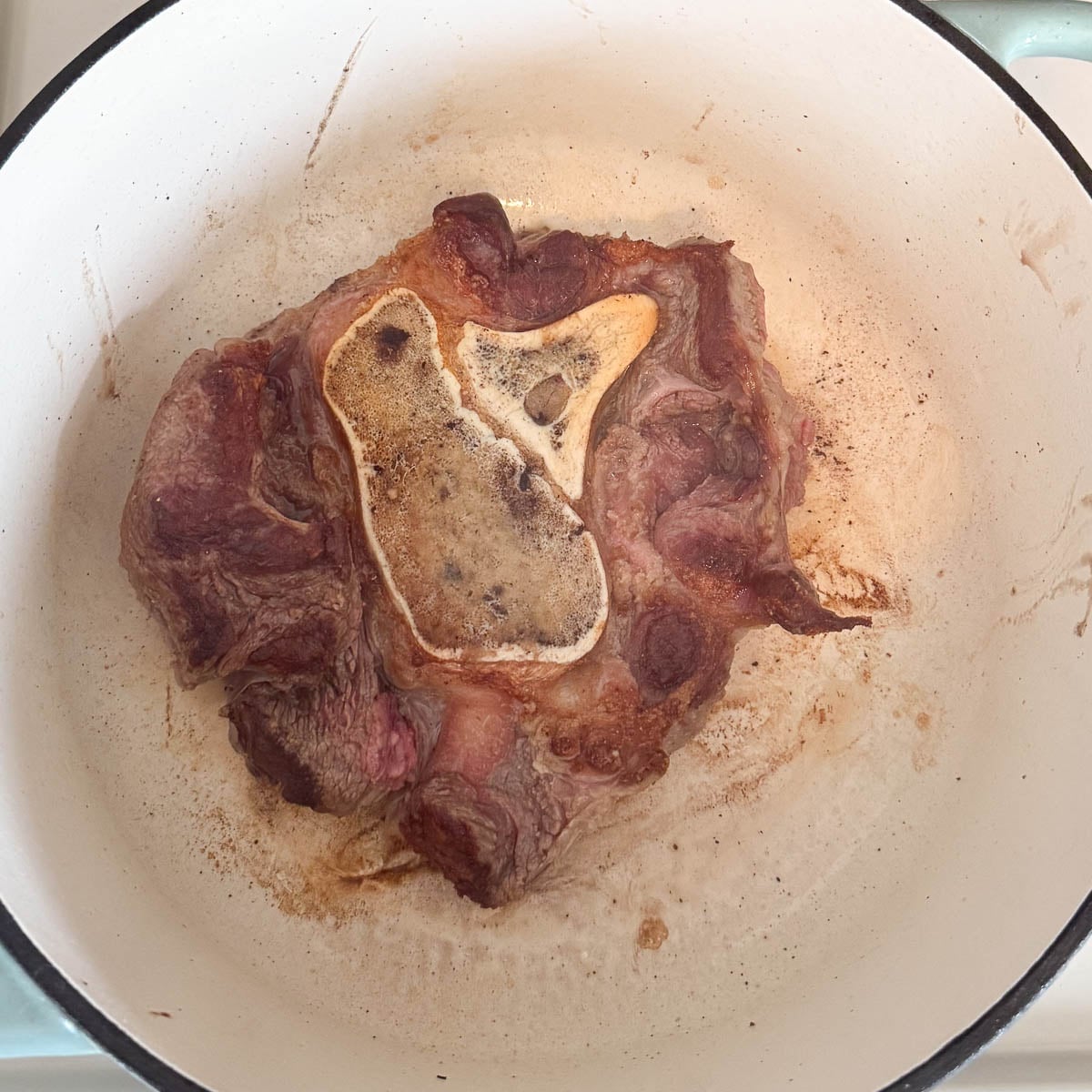 beef shank in pot after searing.