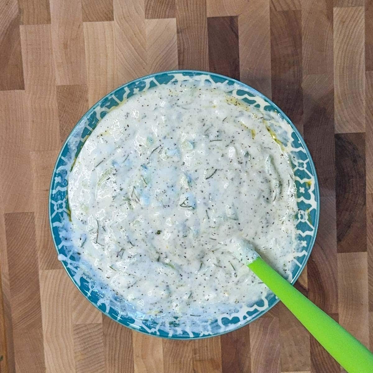 tzatziki sauce in a blue and white bowl