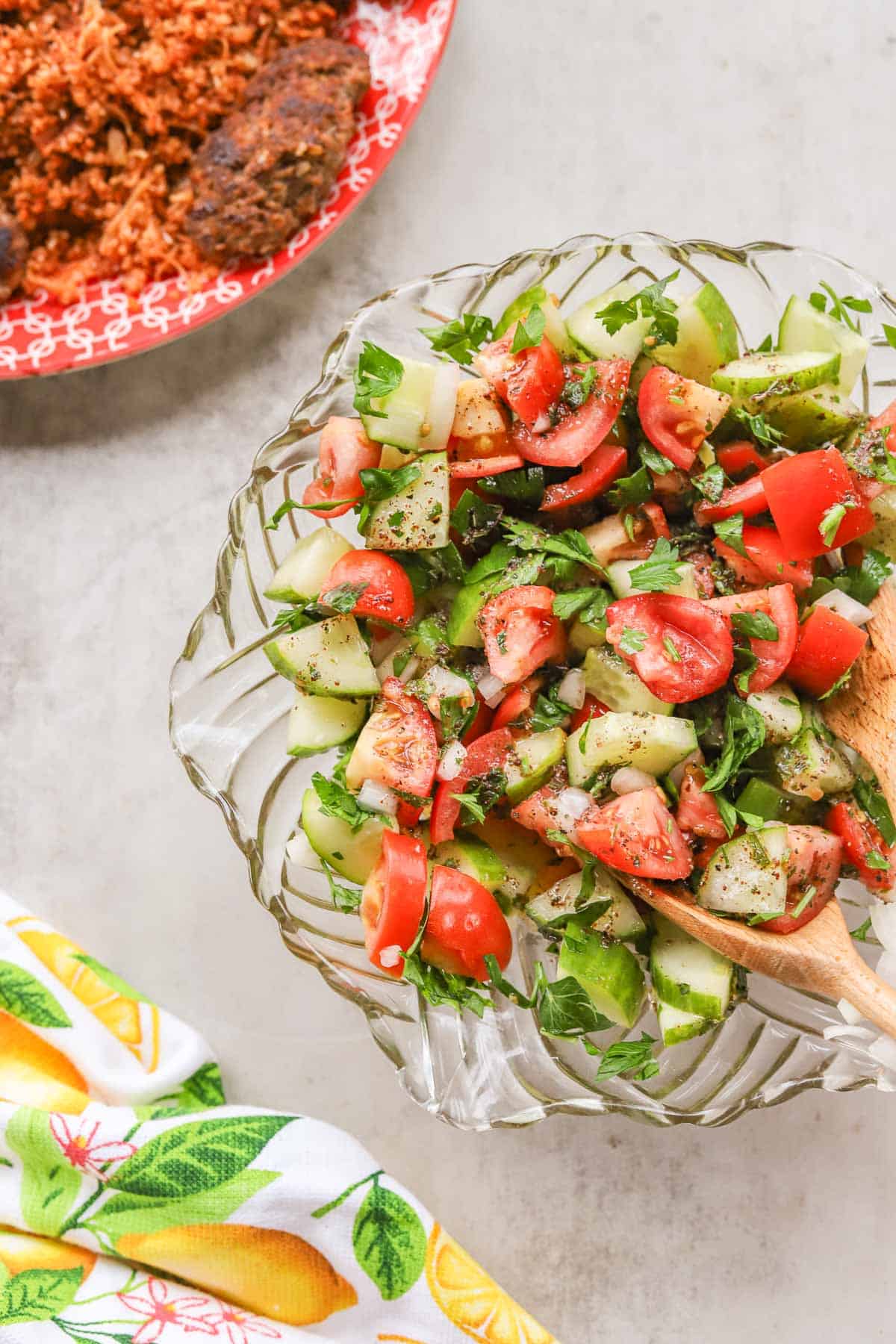 Arabic salad in a glass bowl with bulgur on the side