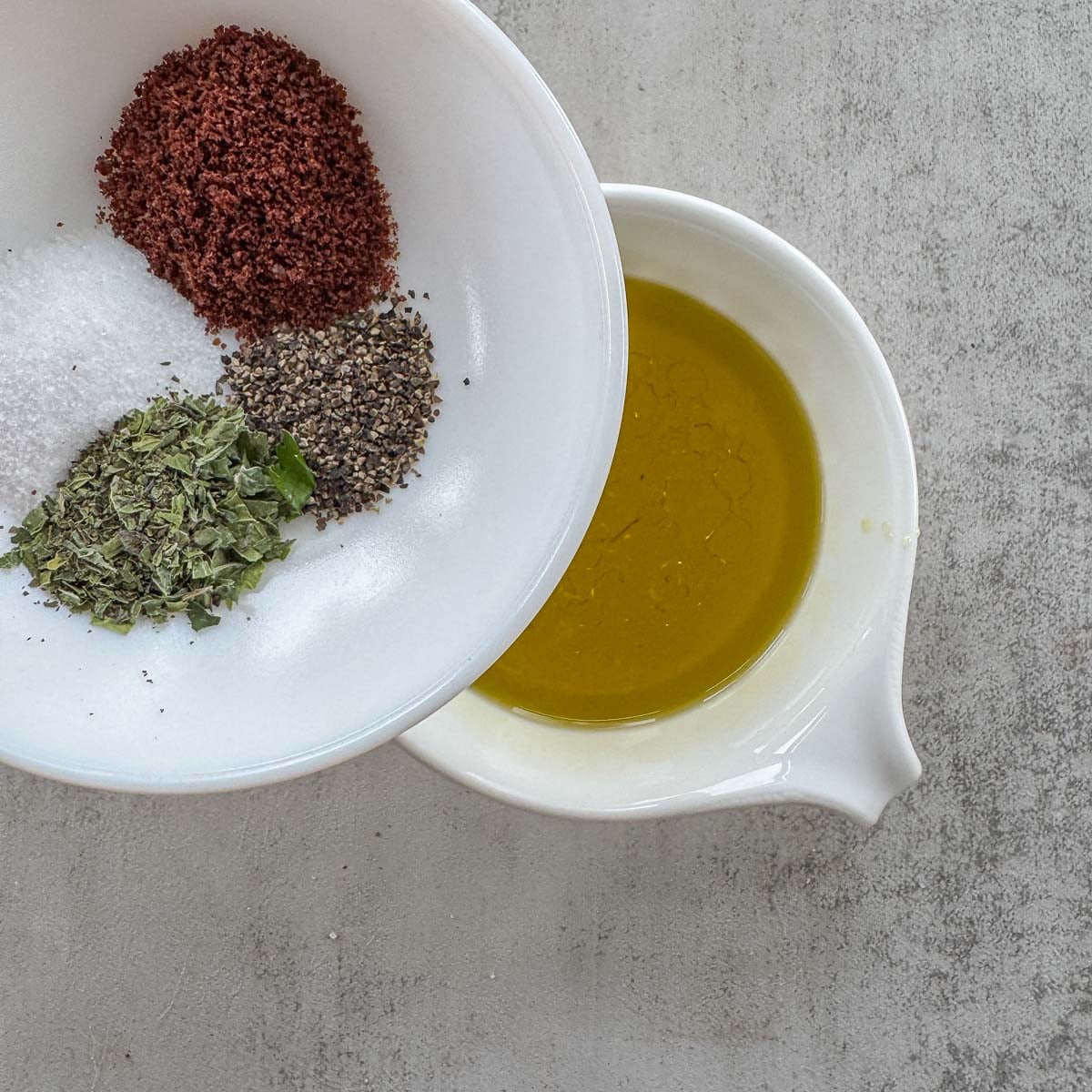 adding seasoning to olive oil