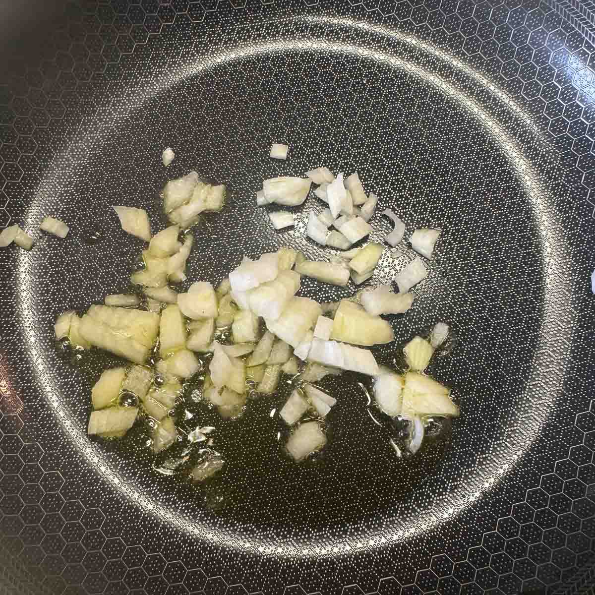 diced onions in a pan