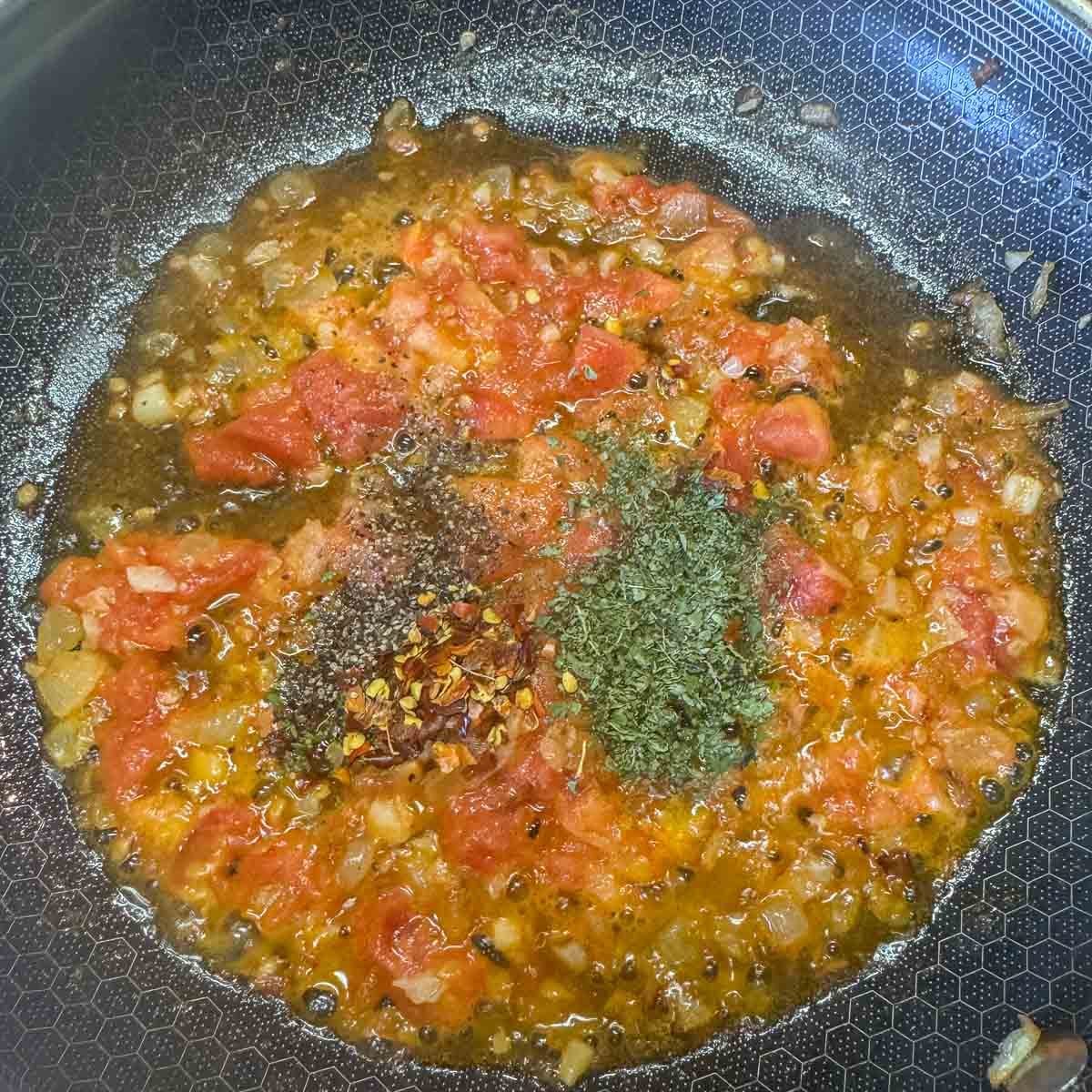 tomato sauce and spices in a pan