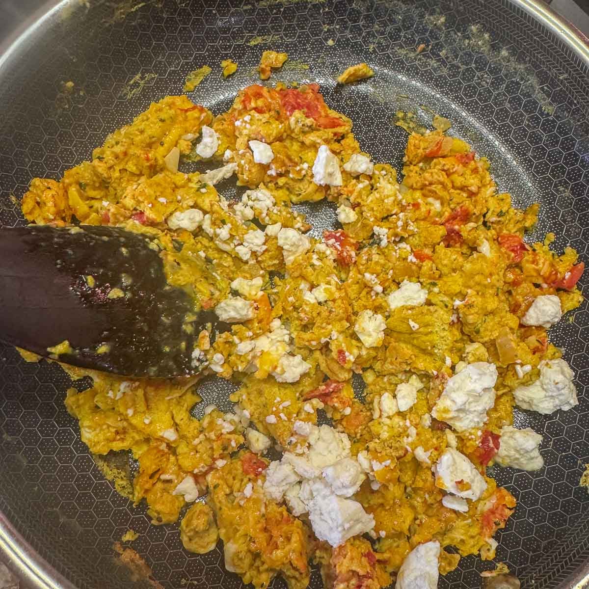 strapatsada in a pan with a wooden spoon