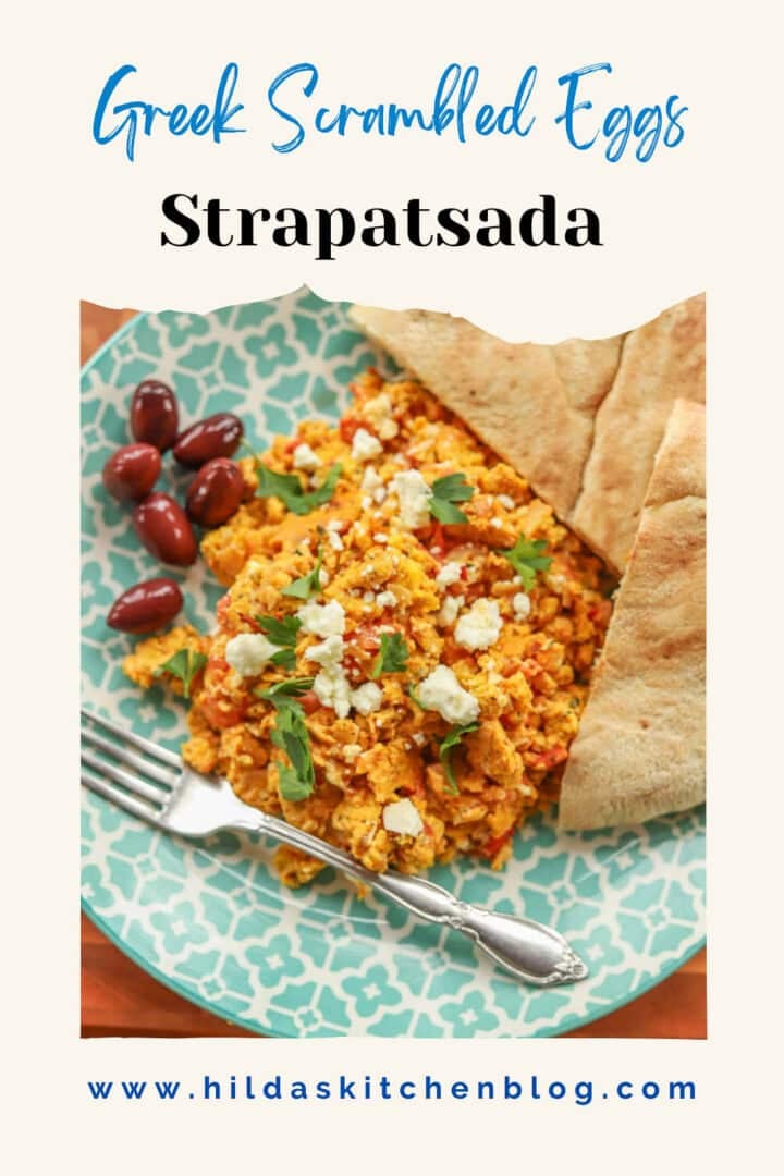 strapatsada with olives and pita bread on a blue and white plate