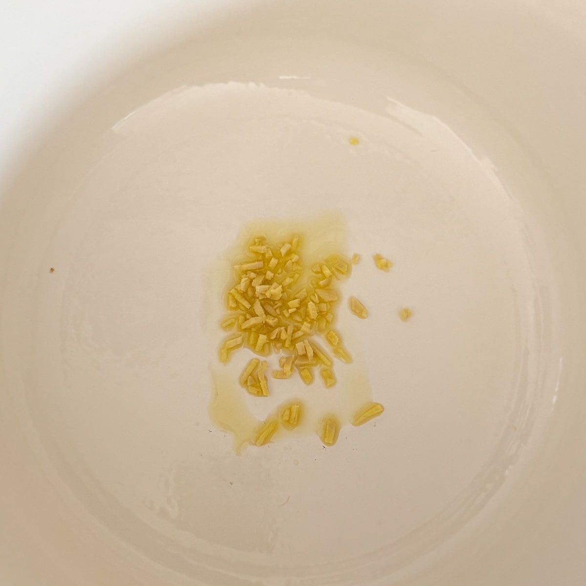 minced ginger sautéing in pot.
