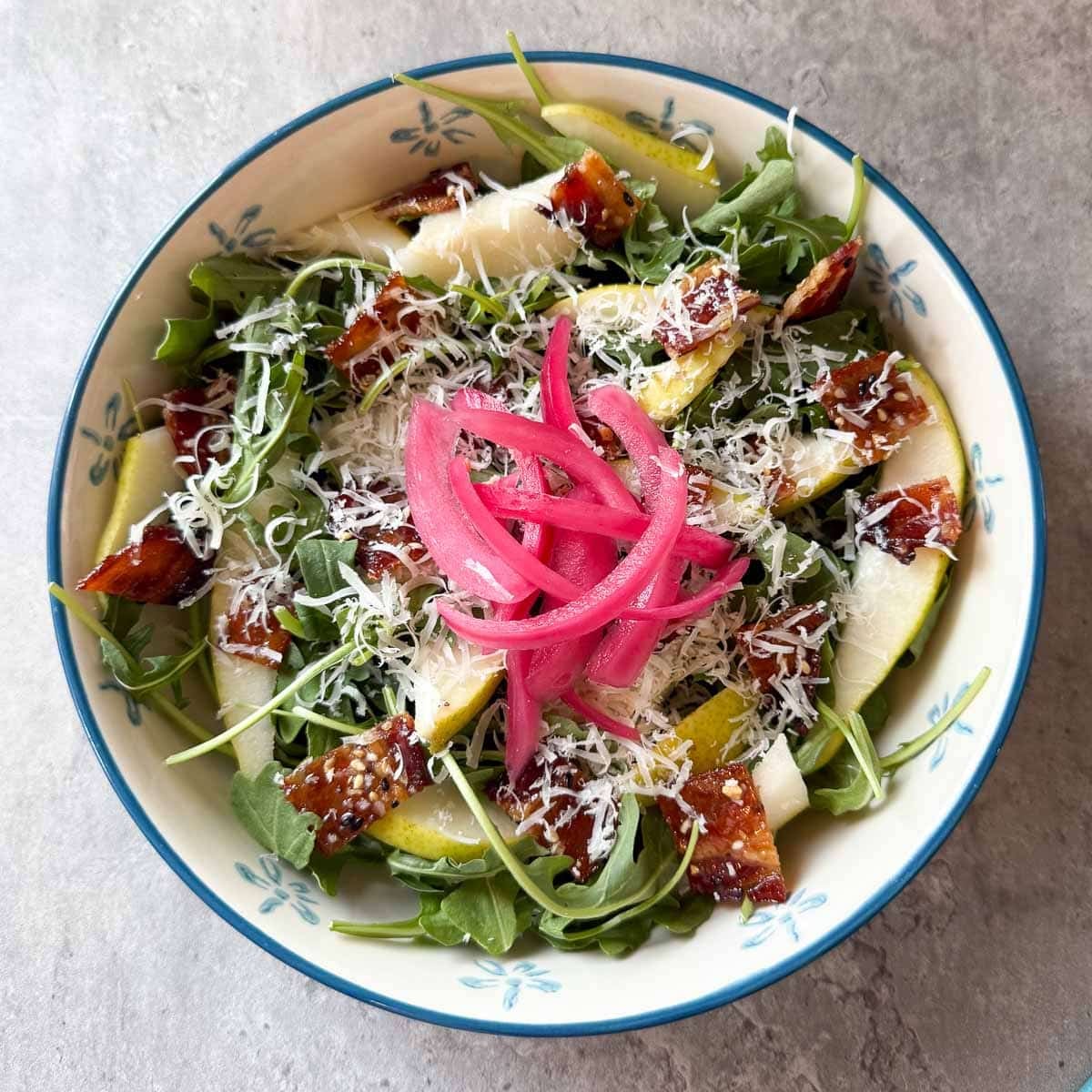 pear rocket salad after adding pickled onion and parmesan.