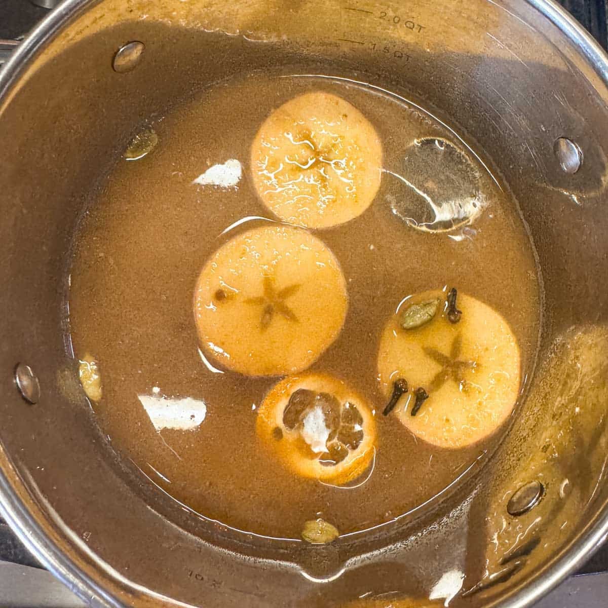 apple slices and spices simmering in apple cider